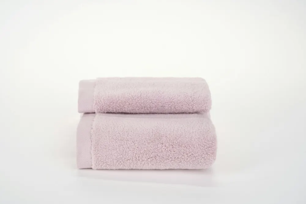 Folded pale pink hand towels
