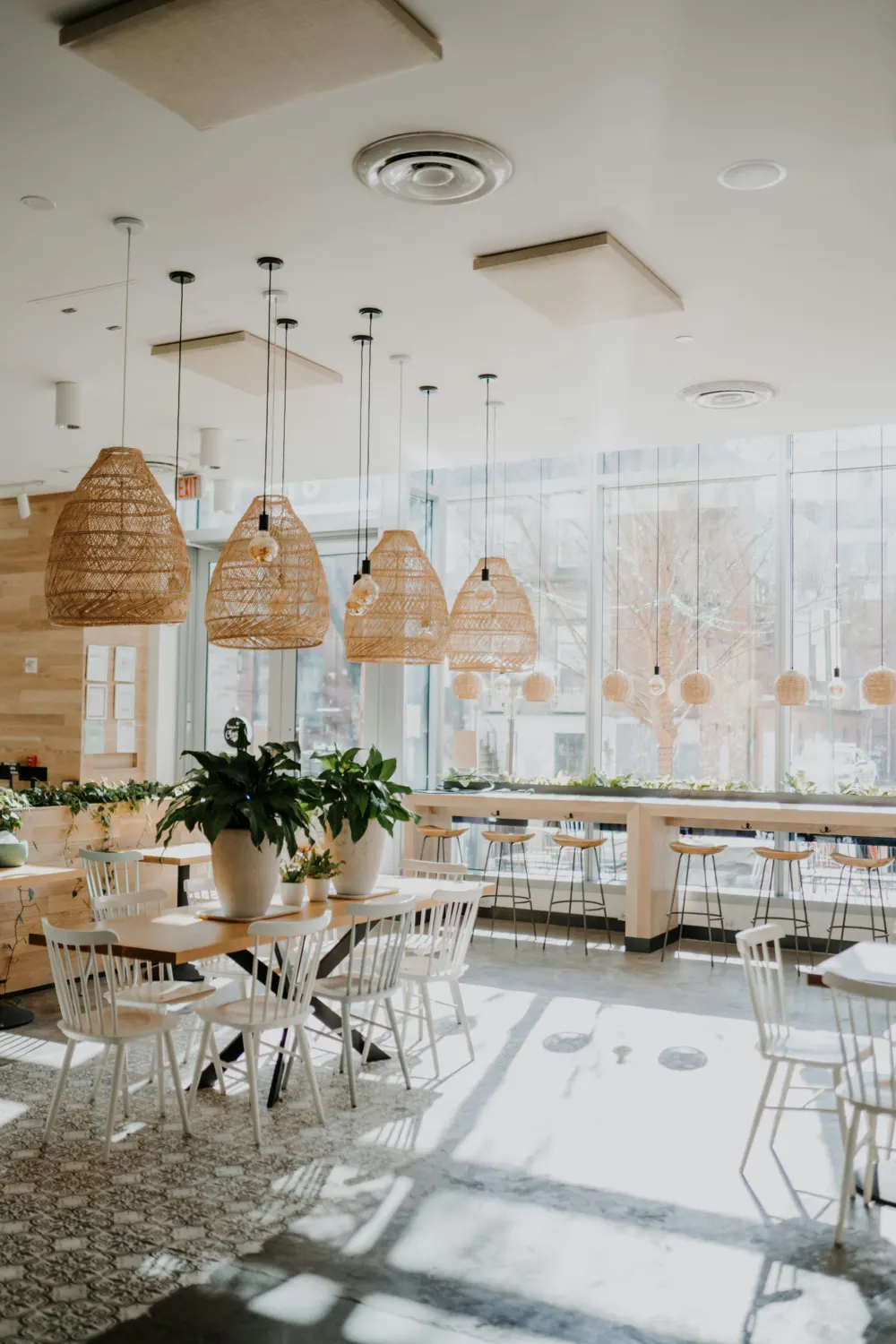 Bright cafe with pendant lights and long tables