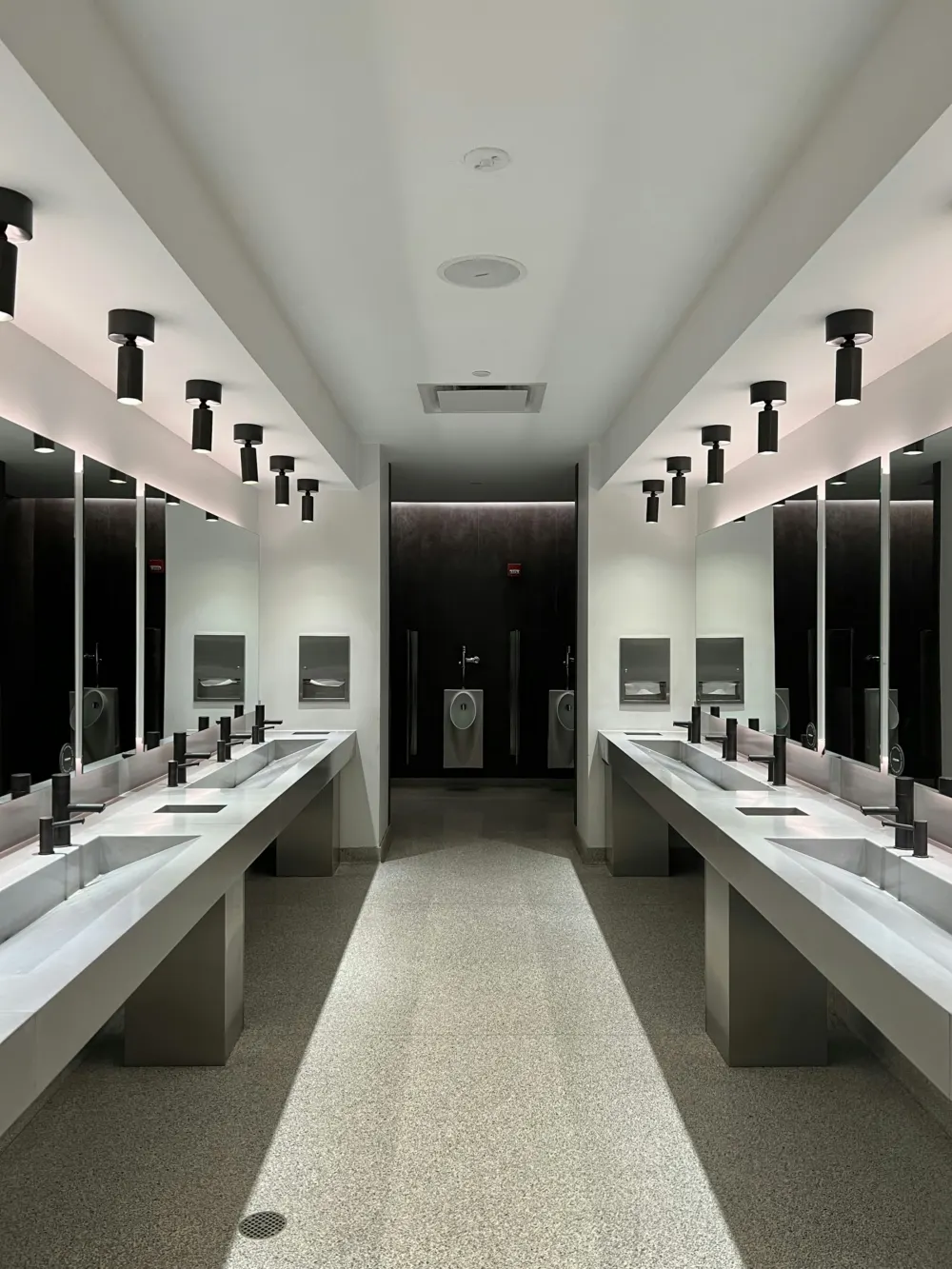 Clean washroom with a row of basins