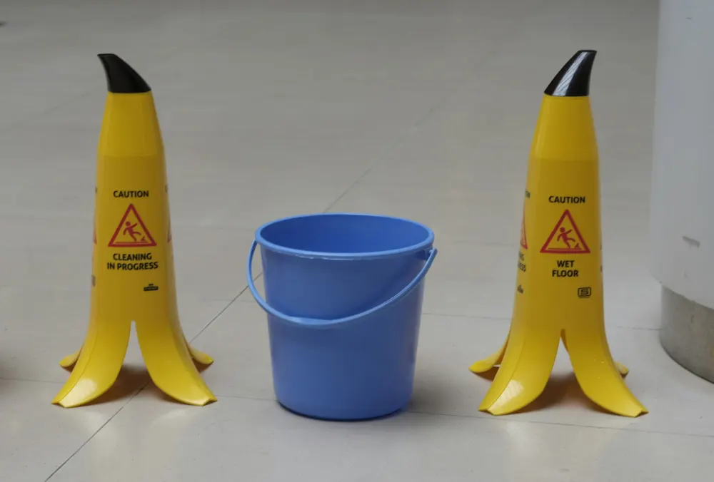 Wet floor signs and a blue bucket